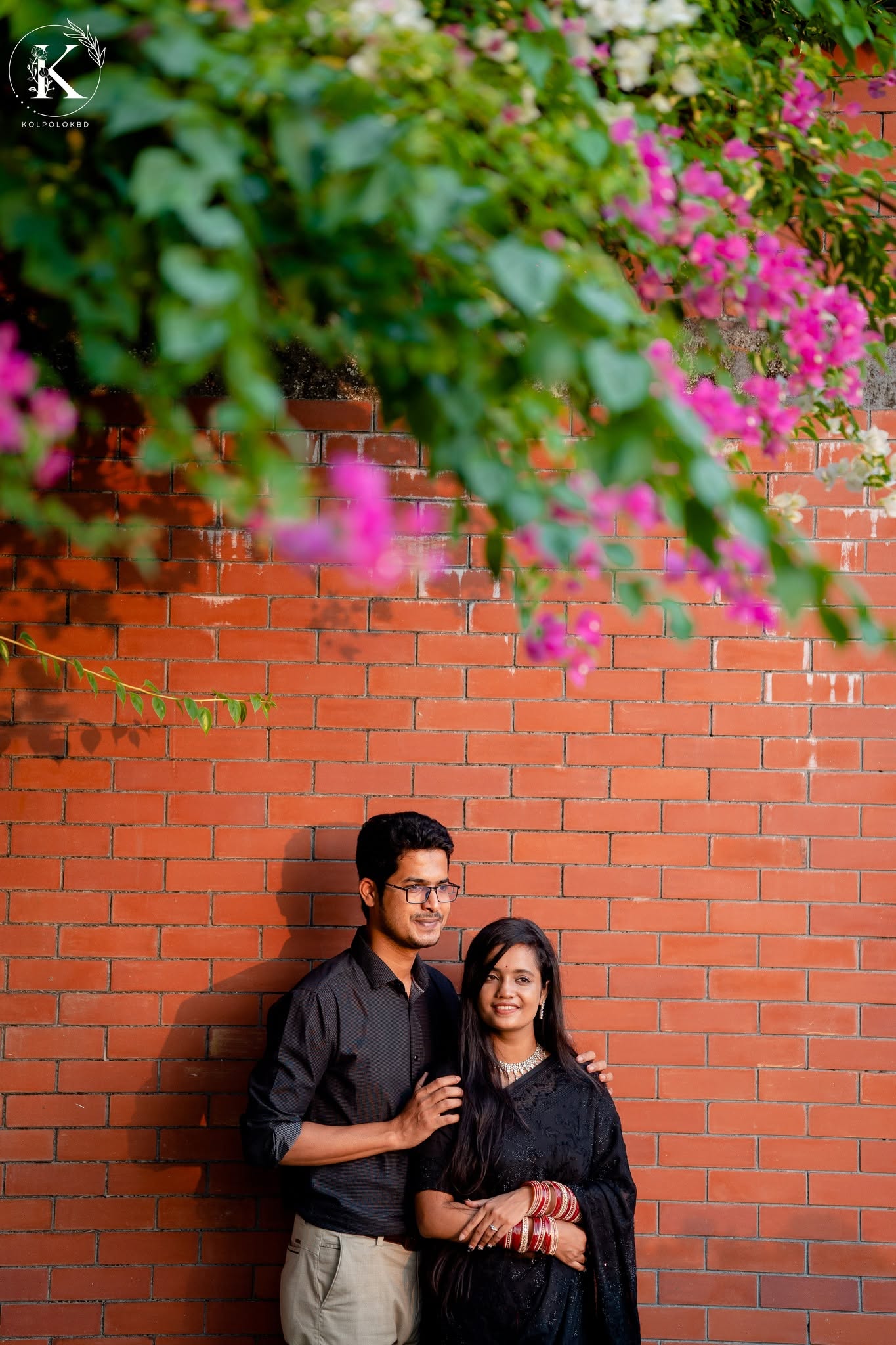 Couple portrait against a brick wall
