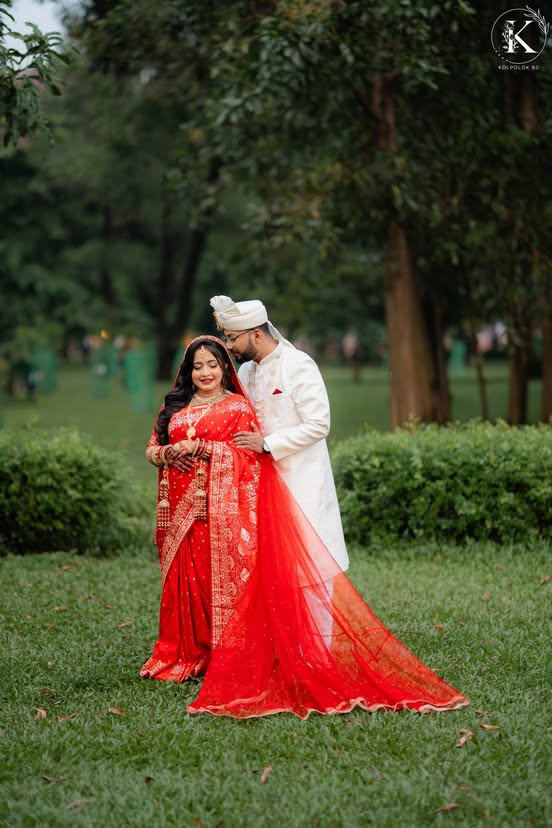 Newlyweds standing in a green garden